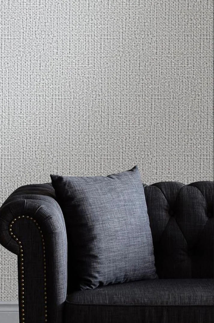 Textura de trama em parede com sofá escuro